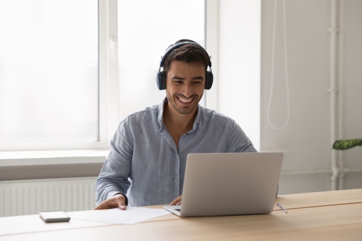 A man smiles while taking real estate investing courses online