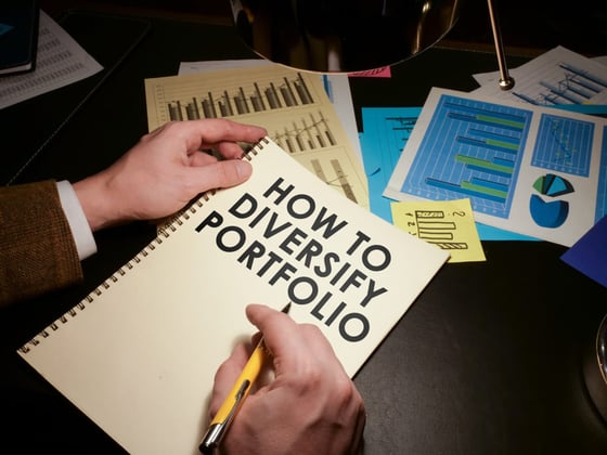 A notebook that says how to diversify portfolio next to charts and graphs