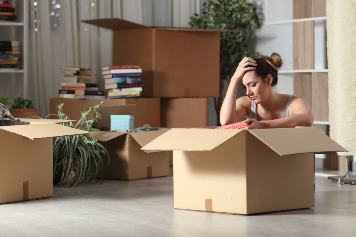 A tenant surrounded by boxes going through the eviction process