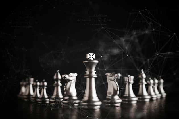 Chess pieces on a black background, creative real estate investing strategies concept