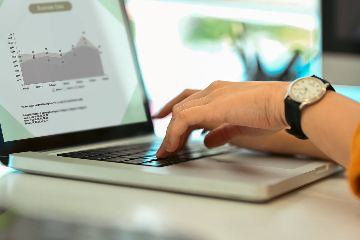 Investor analyzing real estate data on a laptop