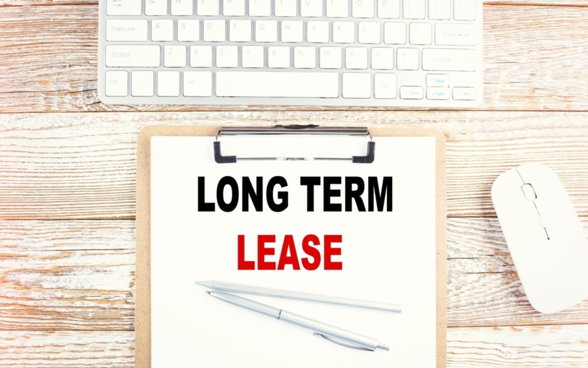 Long Term Lease written on a clipboard, residential lease agreement concept