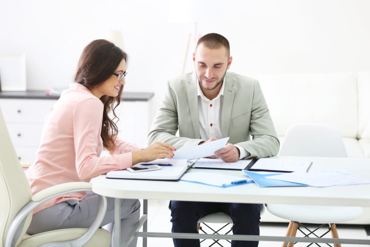 Two people discussing paperwork
