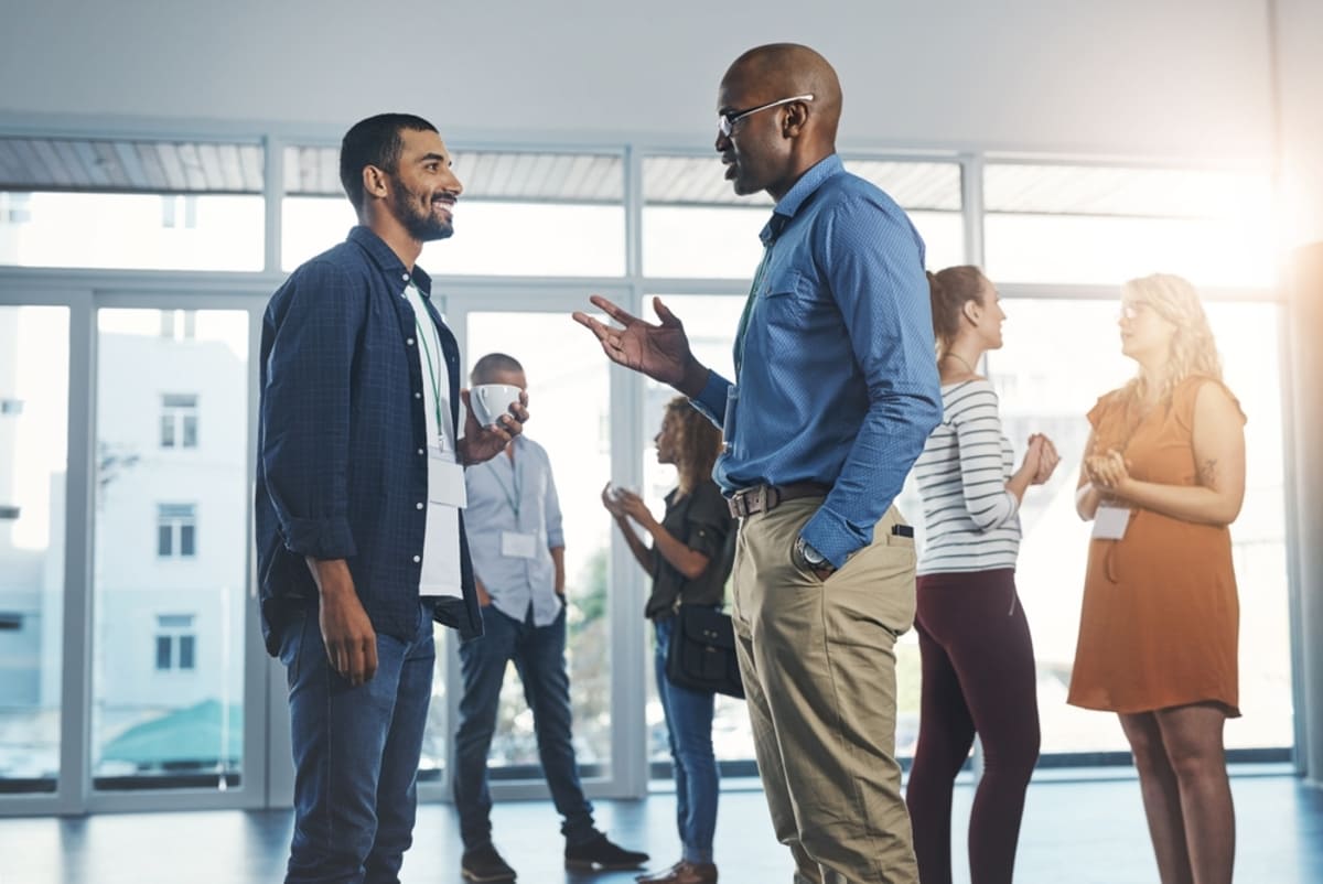 Two people talking at a networking event