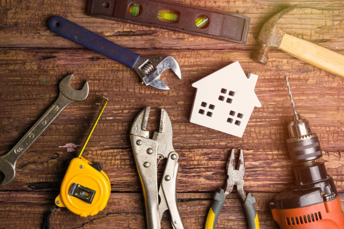 Wooden house surrounded by maintenance tools