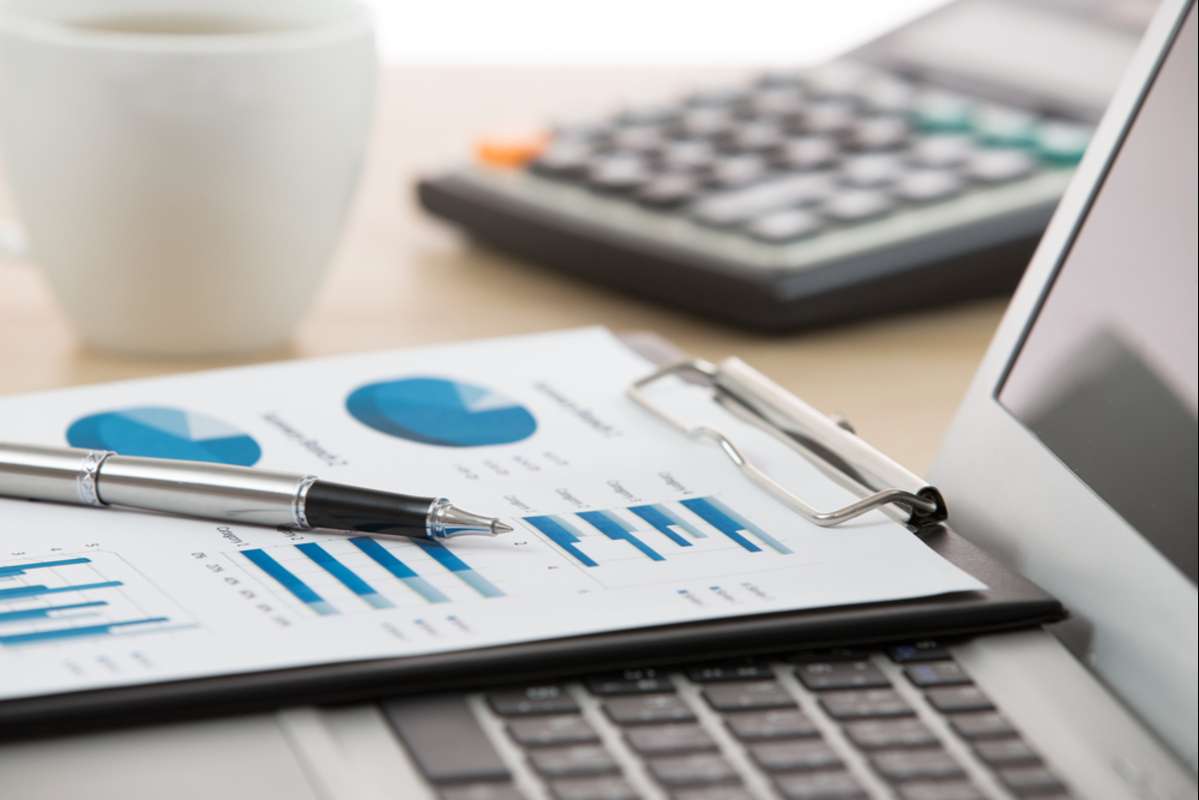 Businessman analyzing investment charts with laptop (R) (S)