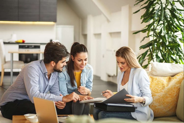 Property manager discussing property income to a couple