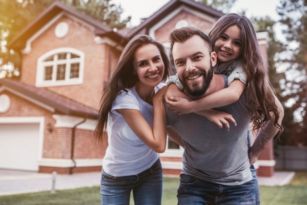 Picture of a happy family in front of their home