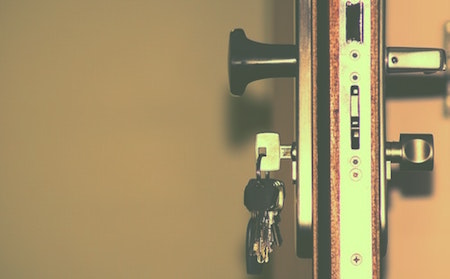 Close-up of door lock and keys, landlord-tenant laws in Michigan concept. 
