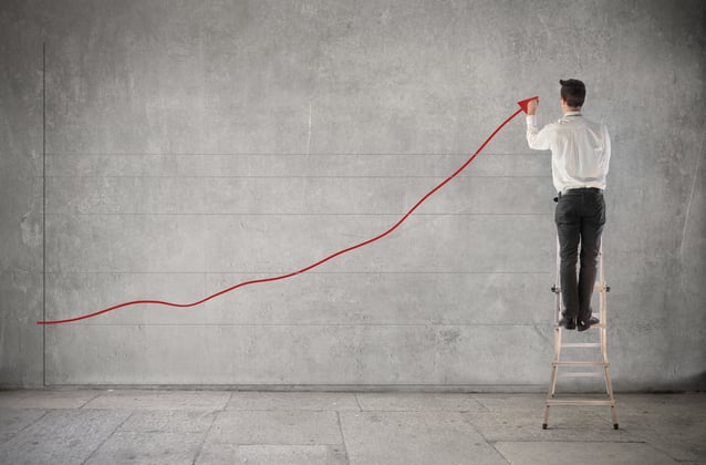 Man in a suit drawing a line forming representation of a graph