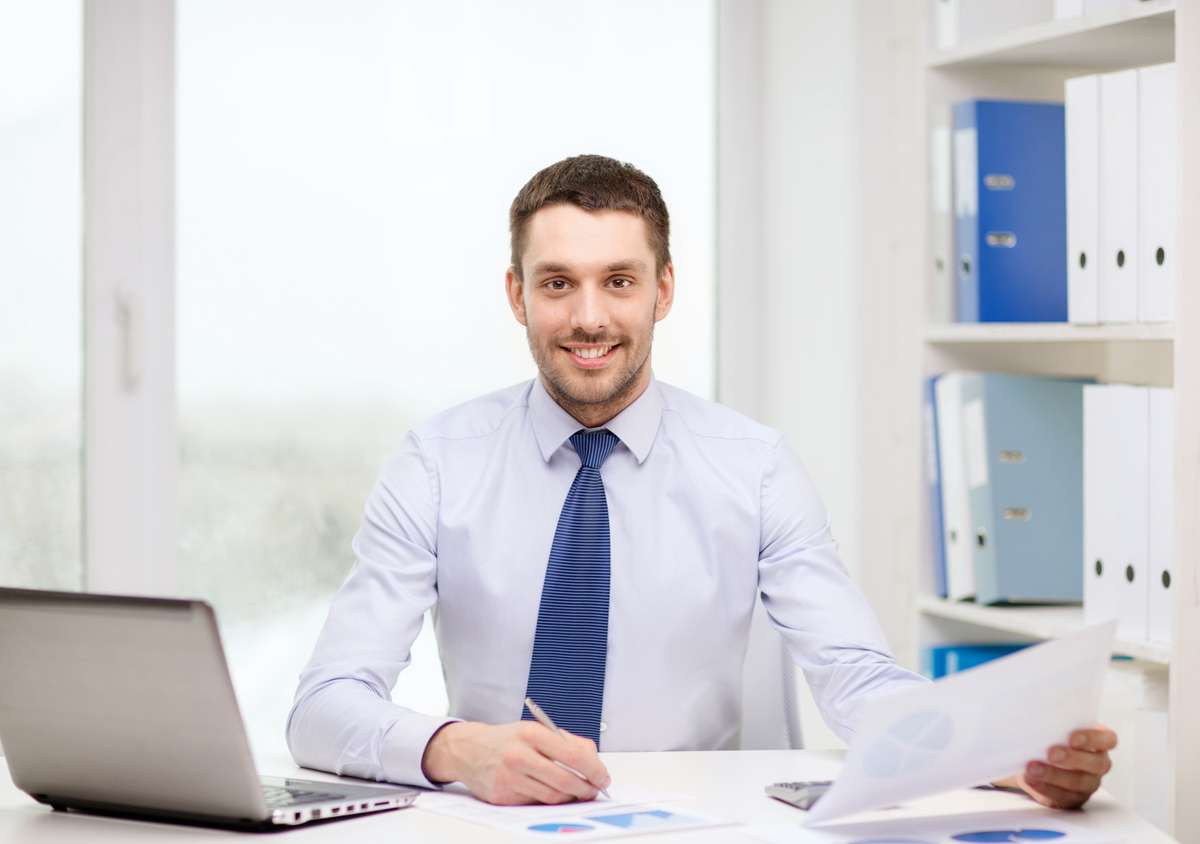 Smiling businessman with laptop and documents (R) (S)