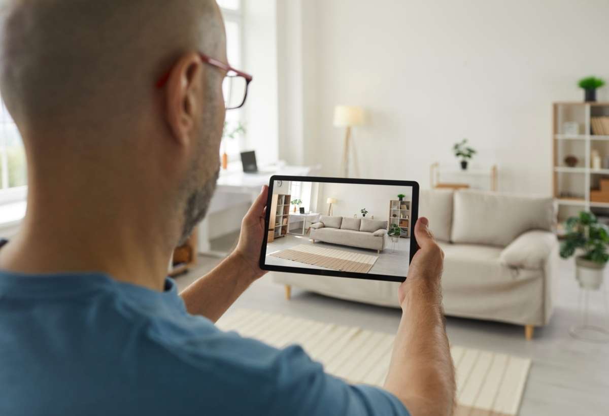 A man takes photos inside a home, Detroit property management company concept