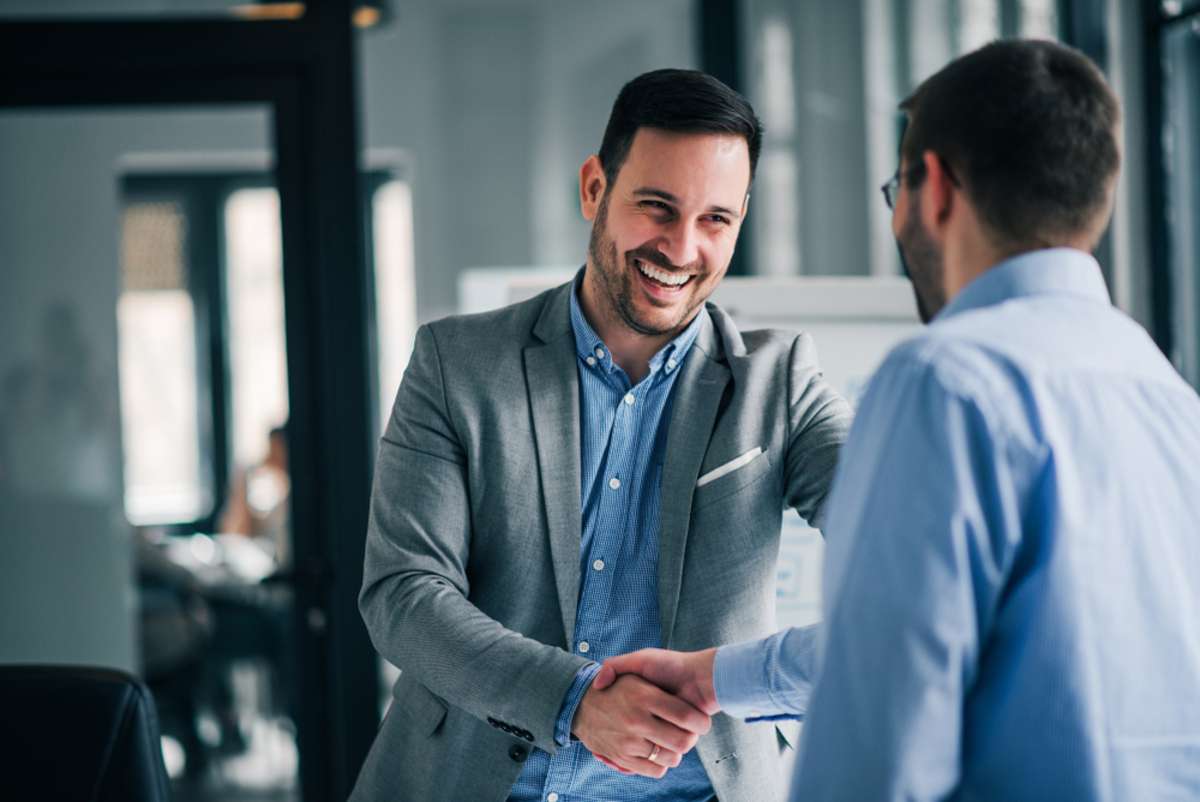 Businessmen shake hands, Detroit turnkey property management partnership concept