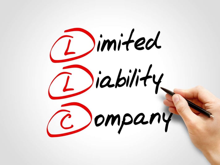 LLC - Limited Liability Company written on white background, LLC for rental property concept. 