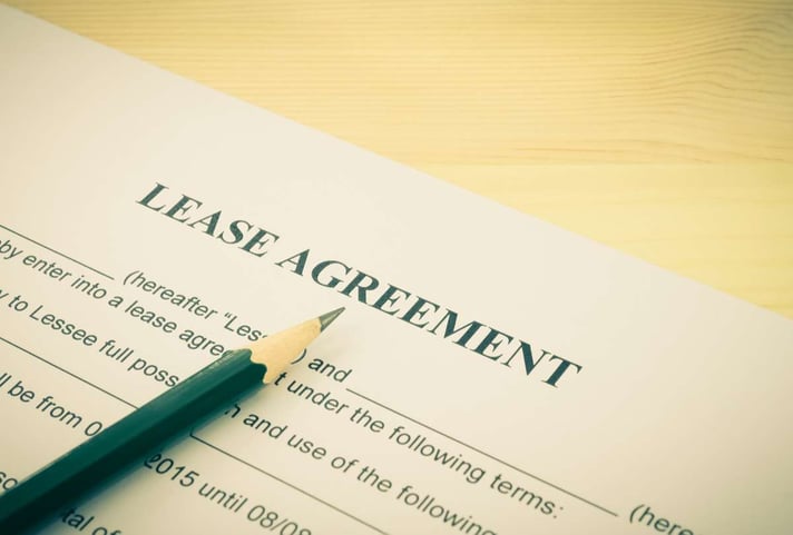 Lease Agreement Contract Document and Pencil, Detroit rental property management concept. 