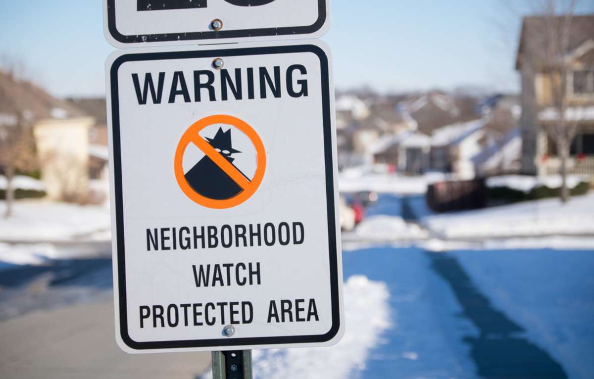 Neighborhood watch sign in a snowy Midwest suburb