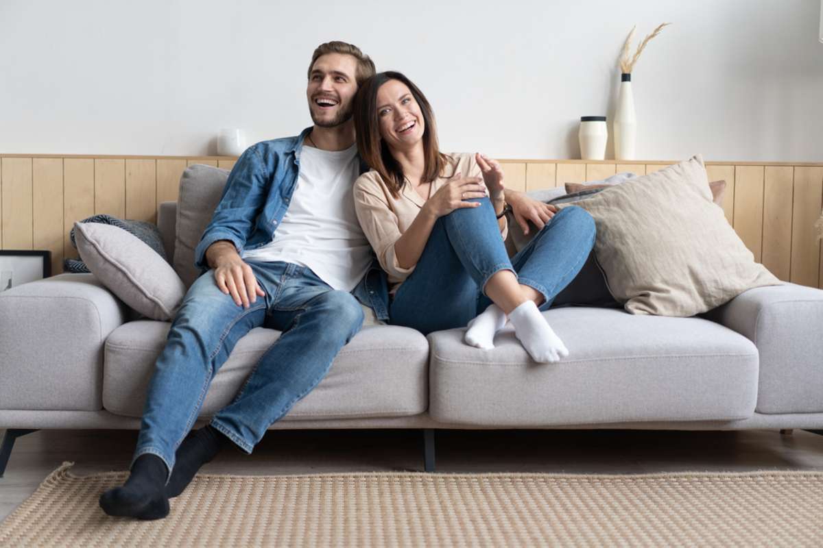 Smiling couple in a new home, move-in checklist concept