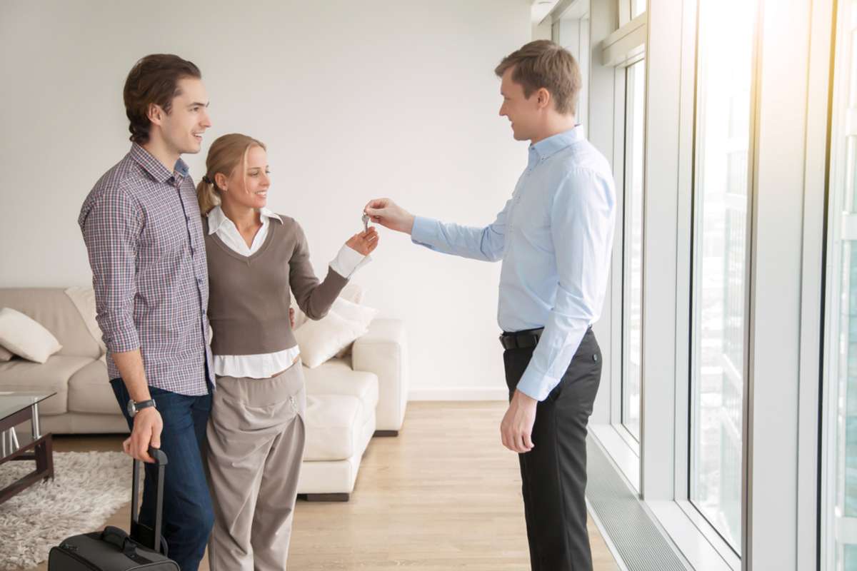 Young attractive married couple in love buying or renting new apartment