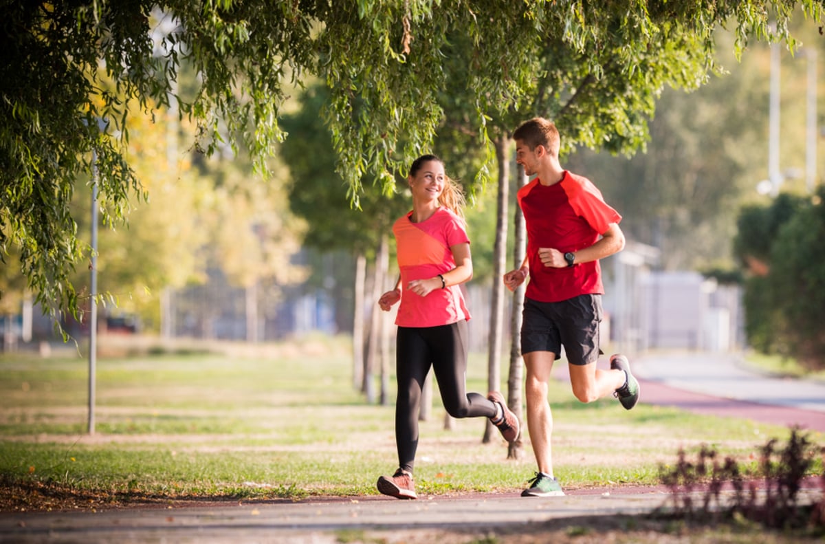 sportive couple running in park