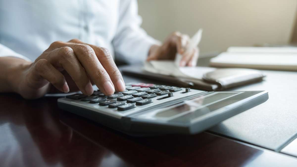 Woman with bills and calculator (R) (S)