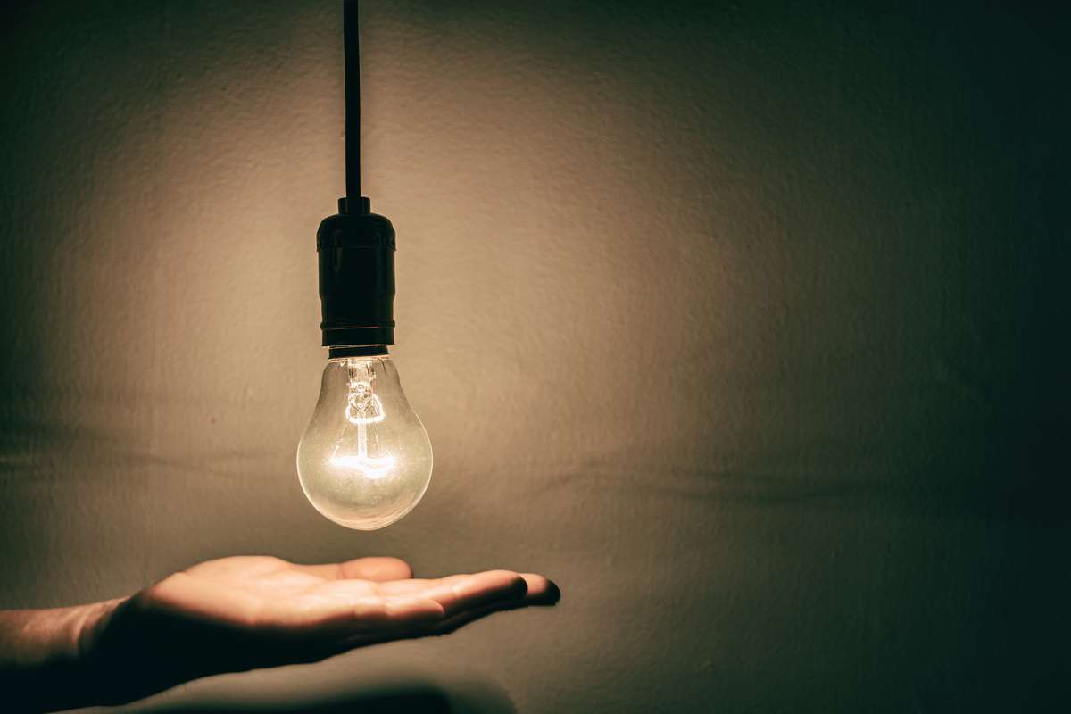 A lightbulb over a hand