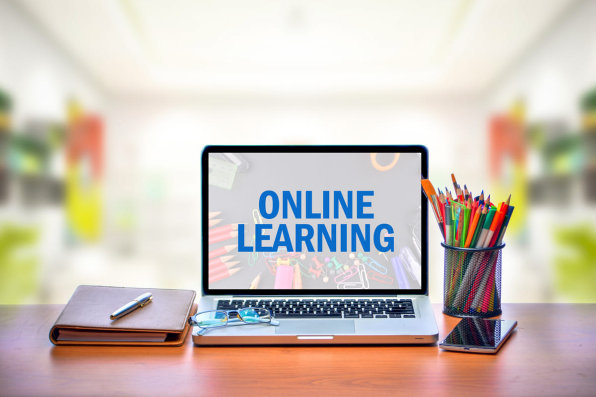 Online learning on a laptop screen, real estate investing courses concept