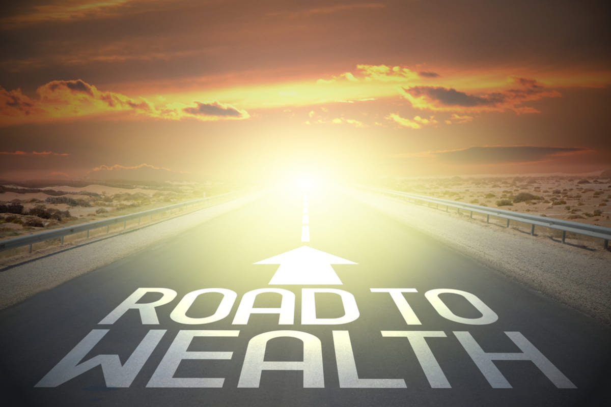 Road to Wealth with an arrow pointing ahead, building wealth through real estate investing concept