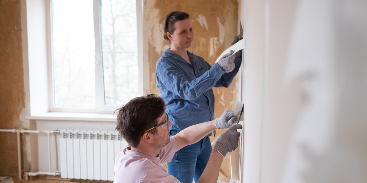 Two people renovating a home