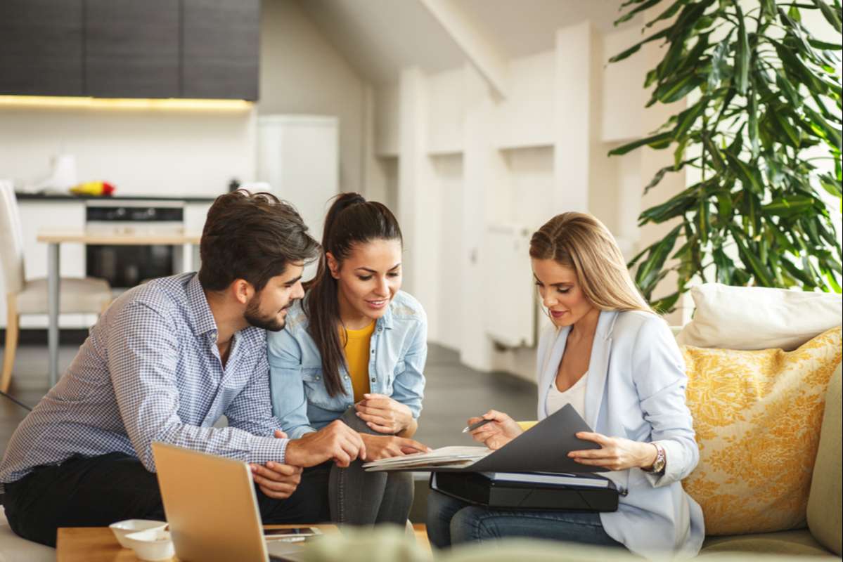 Property manager discussing property income to a couple