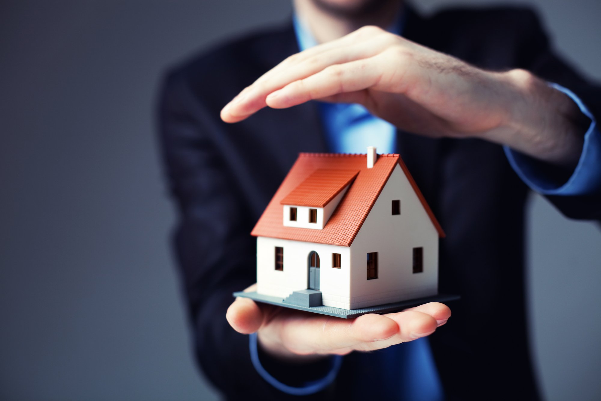 Property manager holding a house model