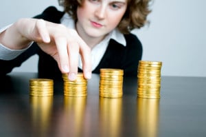 Businesswoman counting a stack of coins