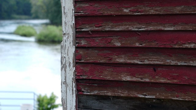 A worn house exterior, normal wear and tear vs. damage concept. 