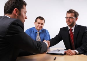 businessmen shaking hands agreeing to a deal