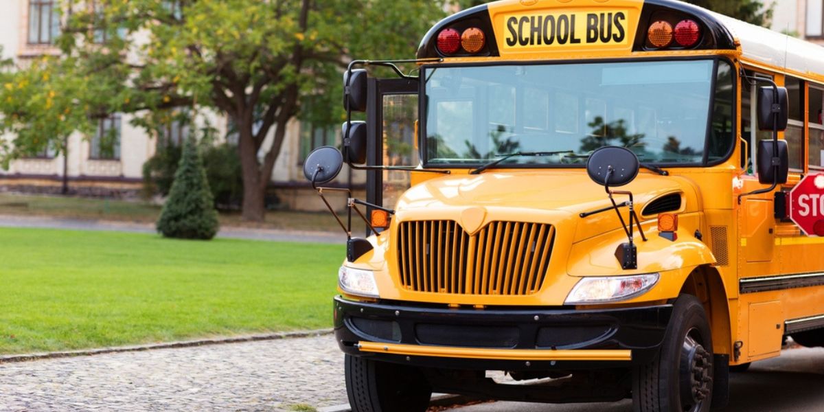 Bright retro yellow school bus stands still on the road