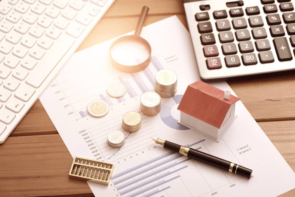 small houses, coins, and office supplies on financial statements