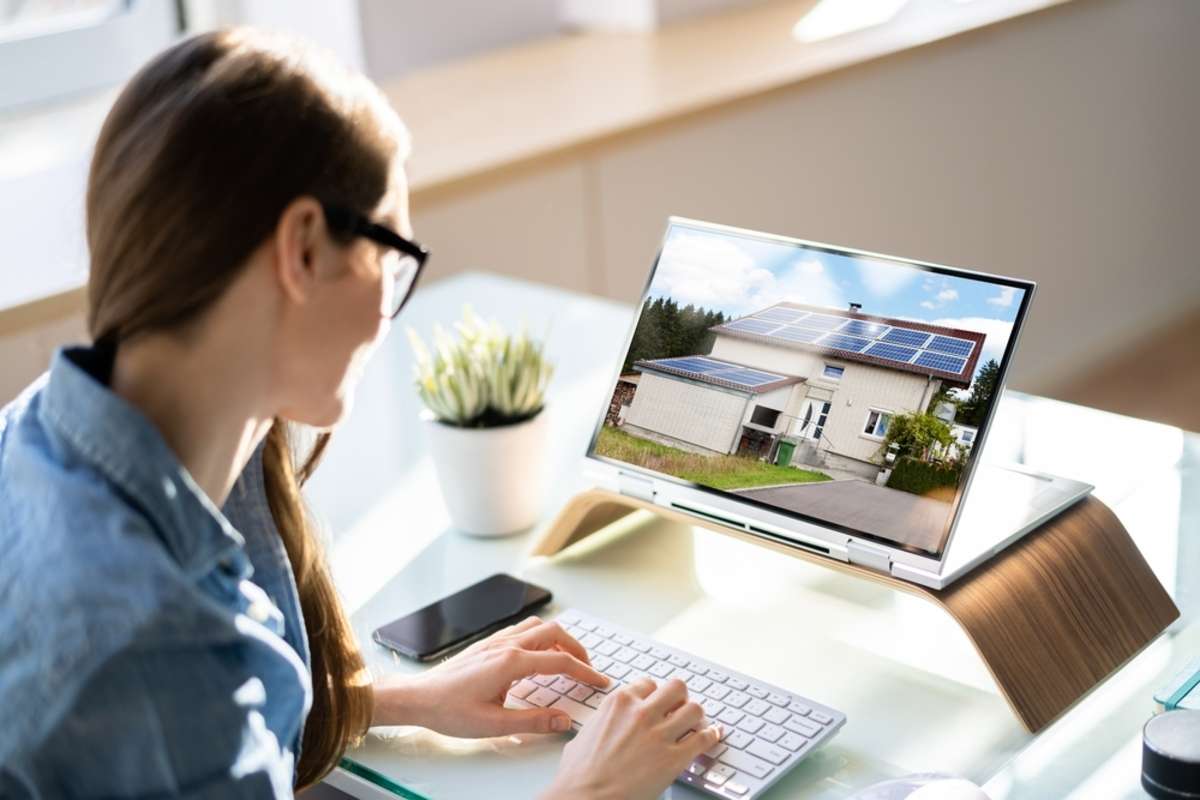  A woman looks at a property listing on a screen, property management tips concept