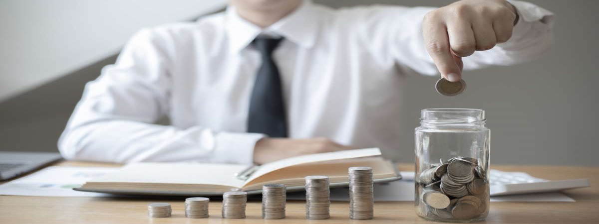 Financial businessman with coins put in a jar, Saving money for future growth